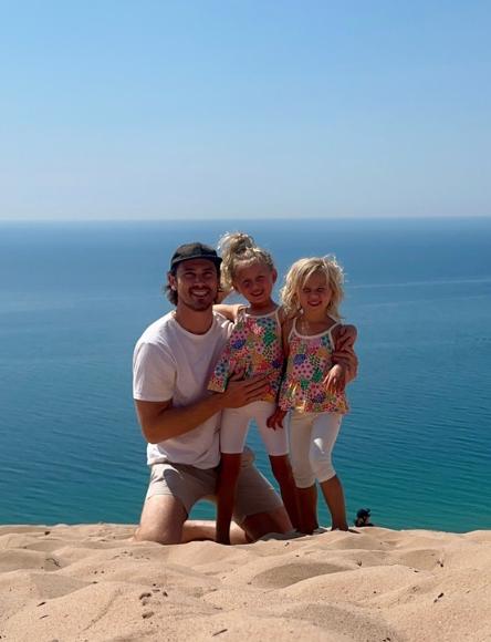 Image of Derek with his kids at the beach